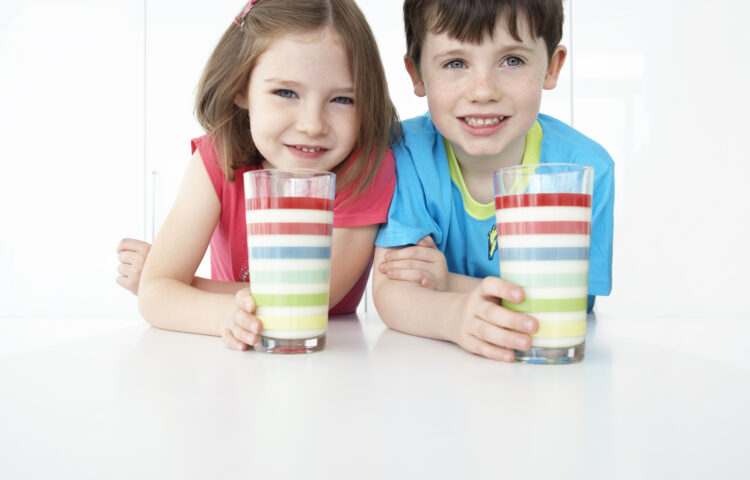 Boy and girl drink milk with lots of vitamin D and calcium