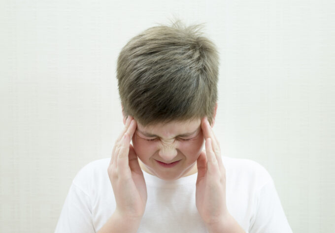 A young teenage boy with a headache.