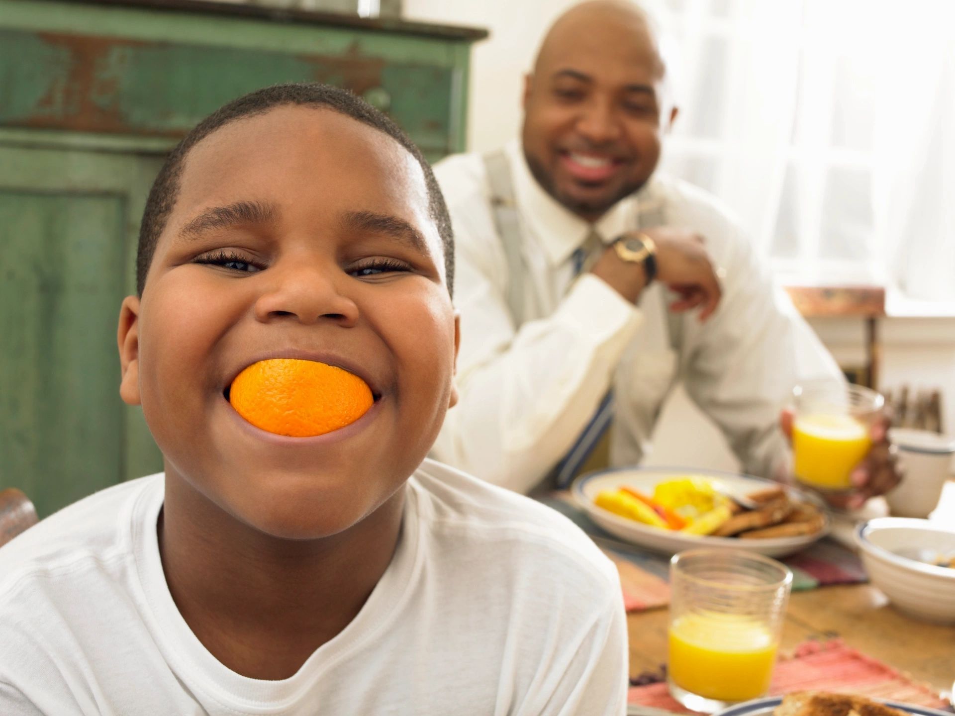 Boy with orange peel for smile