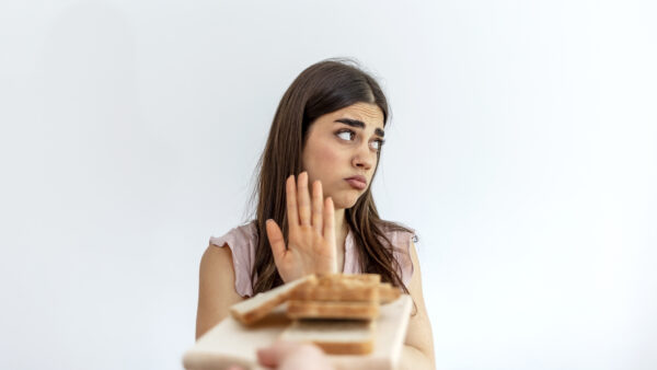 teenage girl refusing sandwich