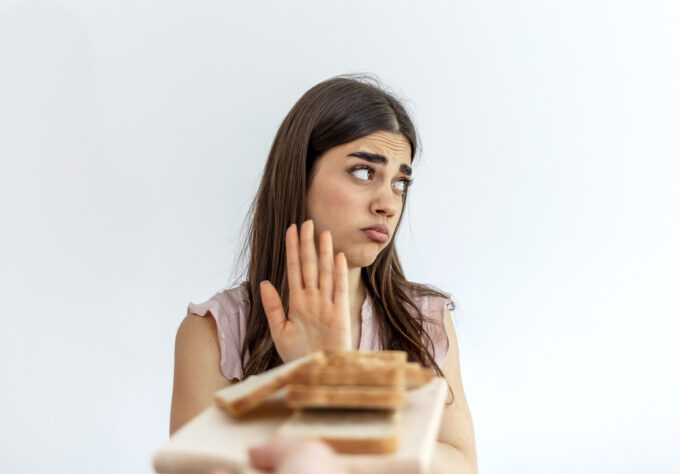 teenage girl refusing sandwich
