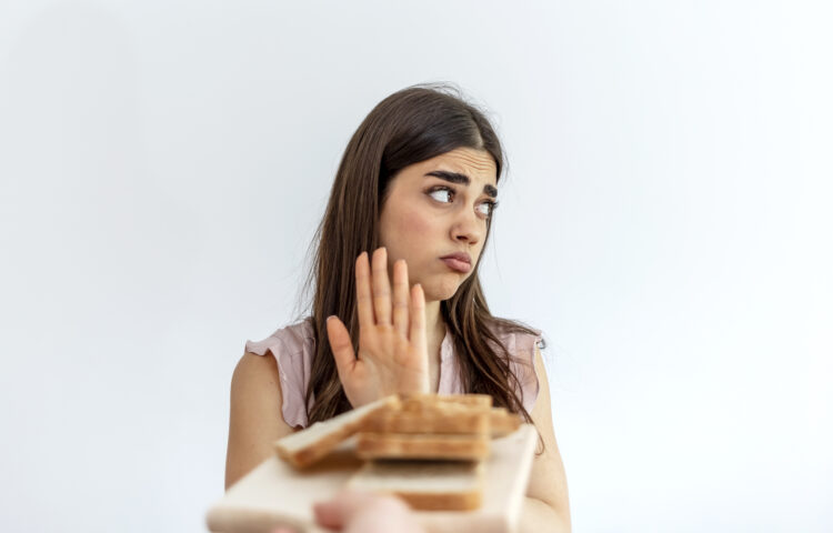 teenage girl refusing sandwich