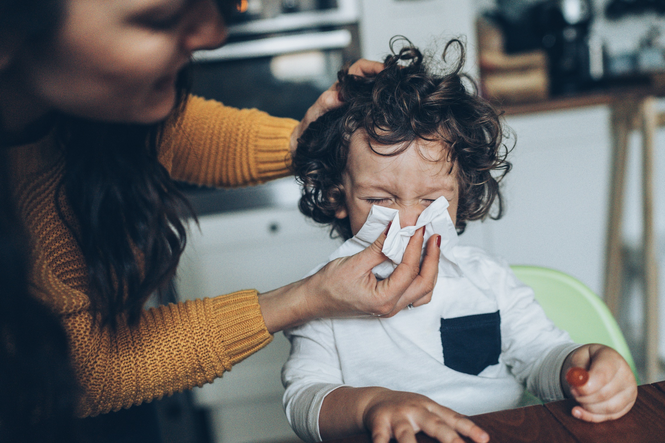 mother helping young child who is sick with parechovirus