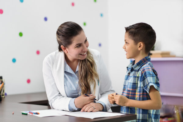 child life specialist talking with young boy providing emotional support and opportunities for learning and play