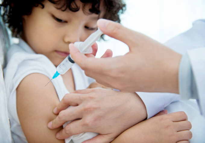 Young boy getting flu vaccine at the doctor's office