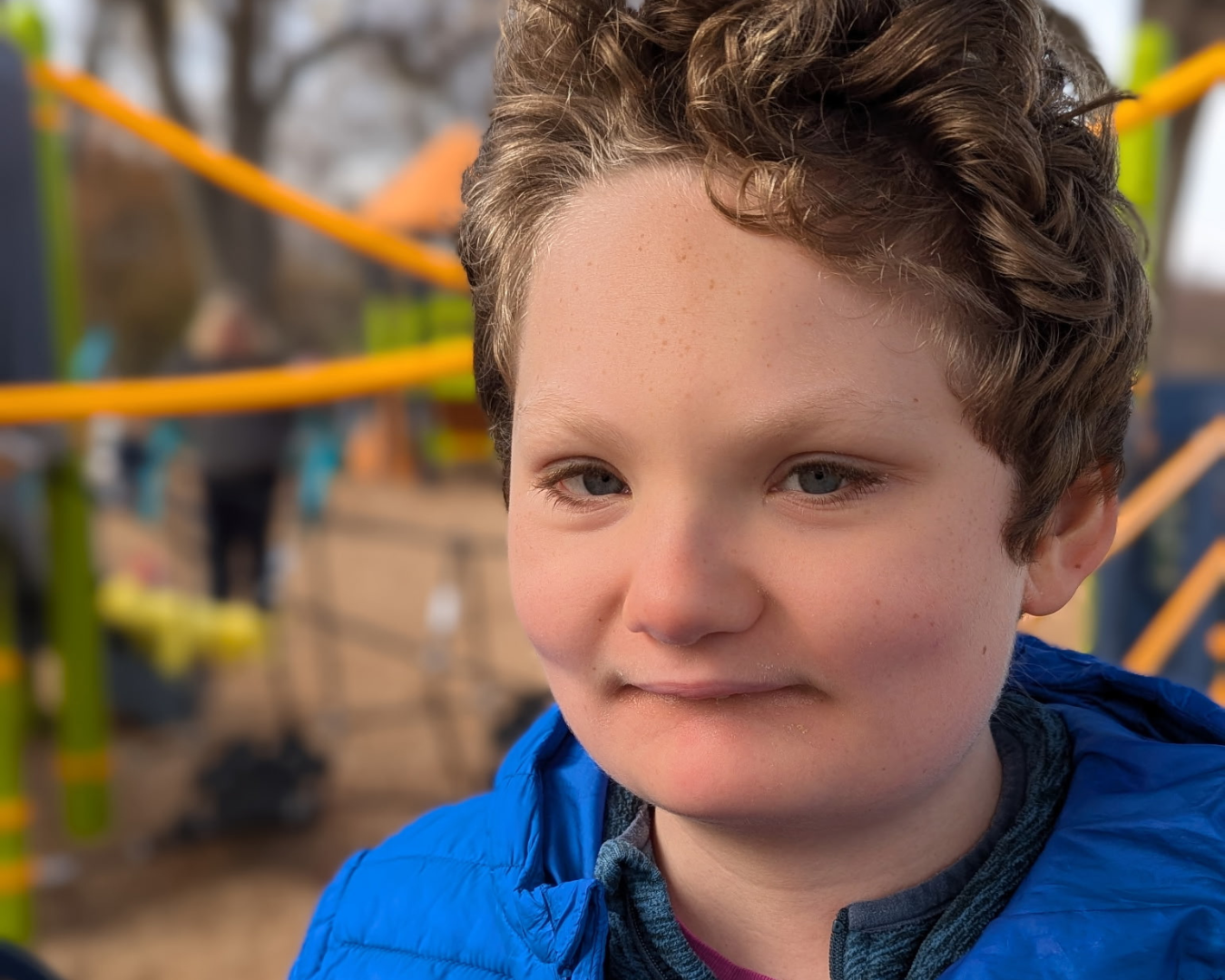 Boy diagnosed with unbalanced translocation playing on playground