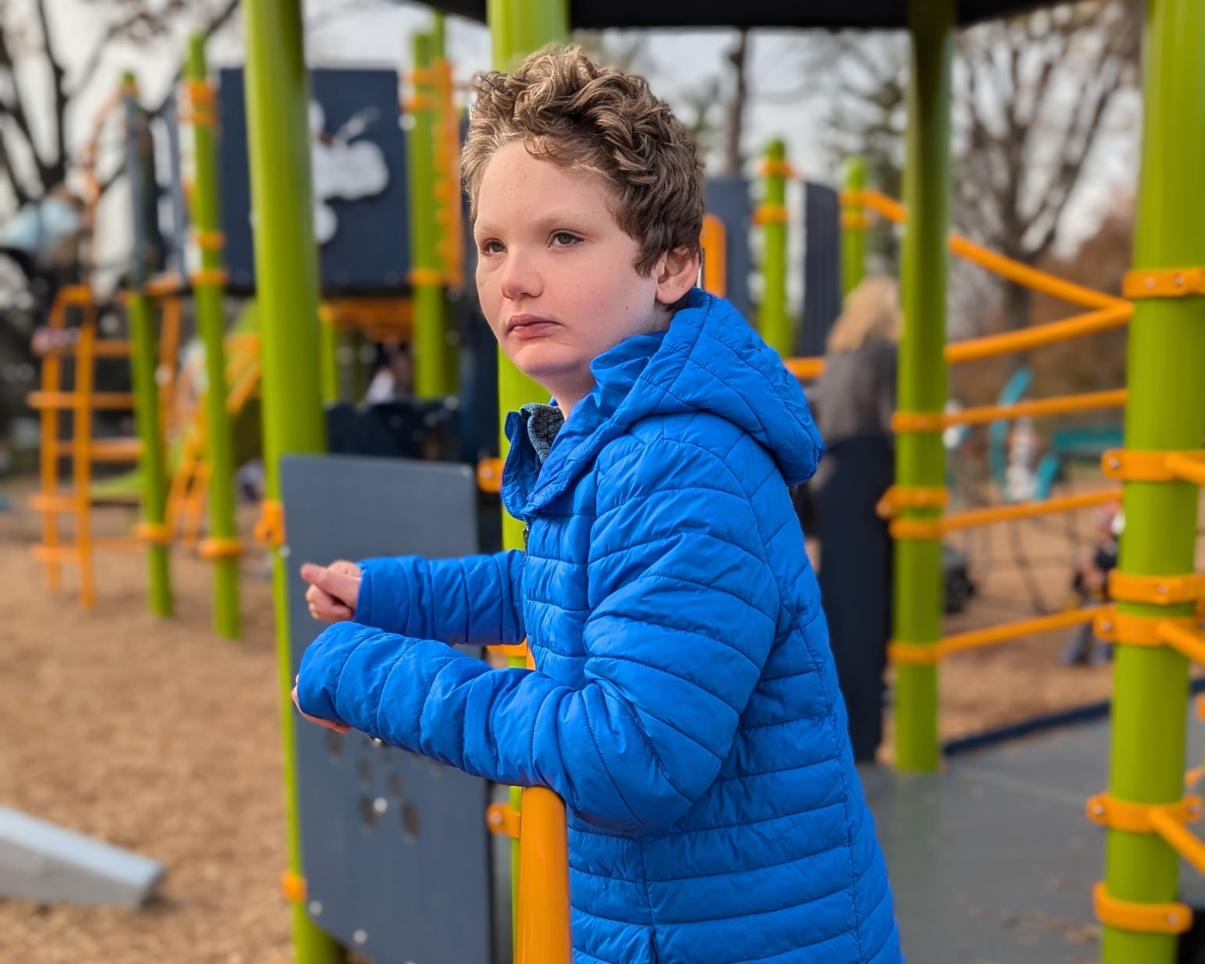 Boy diagnosed with unbalanced translocation playing on playground