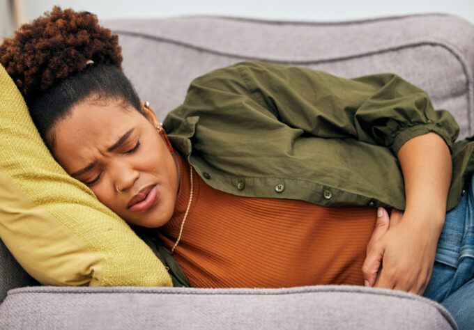 pregnant women holding stomach with either morning sickness or hyperemesis gravidarum