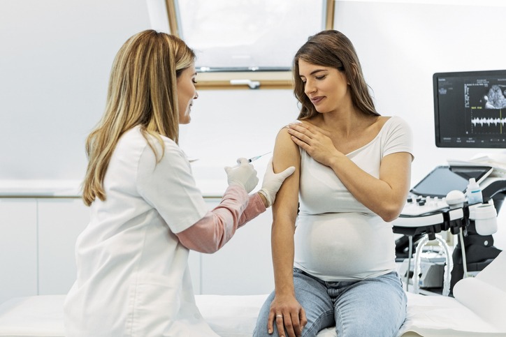 Women receiving a flu vaccine while pregnant to prevent illness.