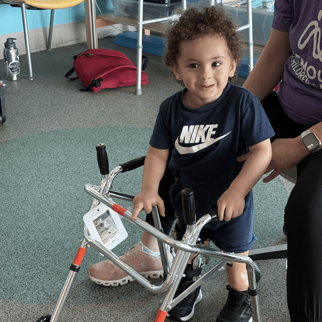 Boy with prosthetic leg participates in physical therapy