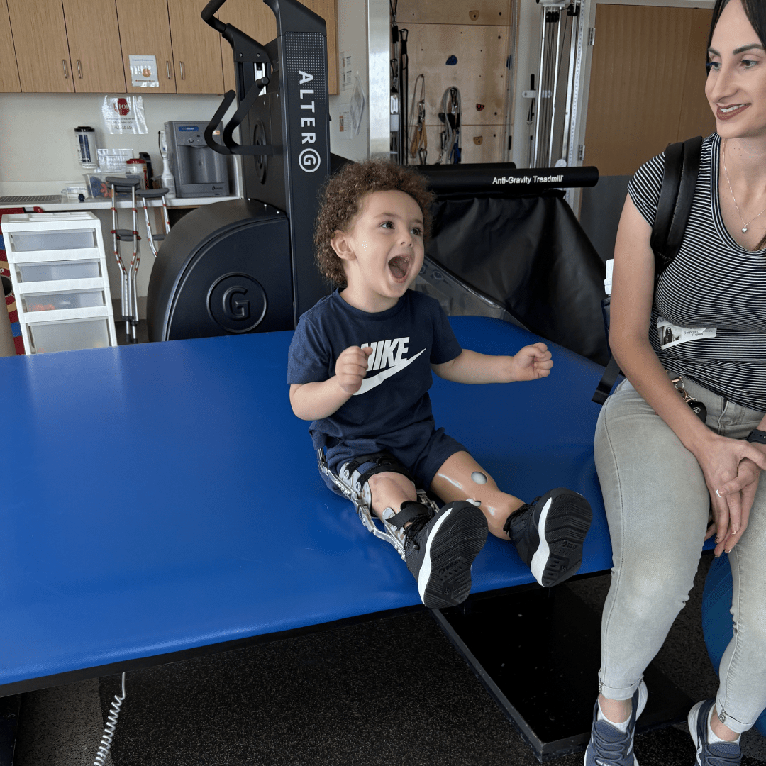 Boy with prosthetic leg participates in physical therapy