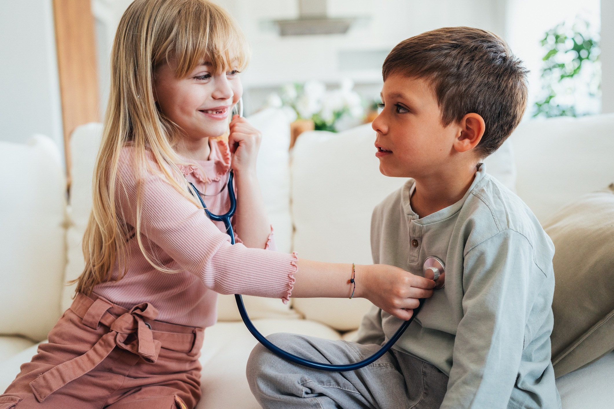 Little kids pretending to be a doctor. Shot of a cute little girl with a stethoscope examining her brother. Children playing doctors.