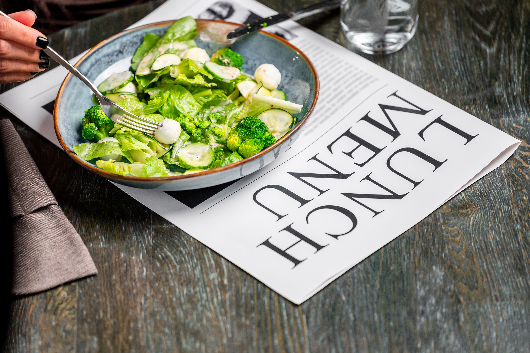 Fresh salad on a newspaper representing headlines about produce safety and the recent cyclosporiasis outbreak linked to fresh produce.