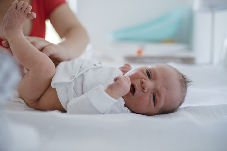 Newborn baby getting a diaper change.
